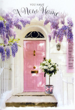 This image shows a sunlit entrance that feels like a secret corner of Northolt, captured at that golden moment just before evening. A pale pink door, freshly painted yet with just enough texture to feel lived in, stands at the centre, framed by whitewashed walls that reflect the light in a soft, creamy glow. Above the doorway, generous clusters of lavender wisteria spill downward in romantic, trailing arcs, each blossom creating a cloud of purple that almost brushes the top of the frame. Their imagined fragrance mingles with that of the flowers below, suggesting a delicate perfume drifting along a quiet lane off Church Road or near Northala Fields. Resting at the foot of the door, a chic grey metal bucket holds a florist's carefully arranged bouquet of white and ivory roses. The roses are tightly packed and sumptuous, each bloom unfurling like a whispered promise, accented with fresh greenery that adds gentle movement and depth. A blush-pink satin ribbon is secured at the base, the bow slightly off-centre, lending the piece a relaxed, human touch rather than something overly formal. Soft shadows play across the stone step, making the whole scene feel calm and private, as though the house is pausing to take a hopeful breath before welcoming its new owners. The composition speaks of moving day in Northolt-keys in hand, boxes still unpacked, and a thoughtful floral gift at the threshold to acknowledge this tender, exciting start. It's an image that quietly celebrates homecoming, congratulations, and the comfort that flowers can bring to a new address.