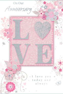 This anniversary card is presented like a delicate floral artwork, ideal for marking years of shared life together in Northolt. The composition centres on the word "LOVE," boldly placed yet soft in feeling, with each capital letter finished in raised, blush-pink glitter that shimmers gently rather than dazzling. The texture appears almost velvety, inviting a slow touch along the curves and angles of the letters. Behind and around this focal point, a misty blush background fades from pale pink to a cooler pearly hue, reminiscent of early morning light over Northolt's quiet residential streets. Flowing over this gentle backdrop is a wreath-like arrangement of illustrated flowers and swirling foliage, finely drawn in silvery greys, pale whites, and powder pinks. The blooms seem to float across the card like petals caught on a warm spring breeze drifting through Islip Manor Park, with each flower defined by graceful lines and subtle shading that suggest layered petals and soft texture. Slender stems twist into loose arabesques, studded with small leaves and tiny buds, giving the whole design an airy sense of movement and celebration. Scattered touches of silver foil glint along some petals and swirls, providing a refined sparkle that echoes the card's romantic intent without overwhelming it. Nestled within the design, an elegant script message about anniversaries and enduring love appears in soft grey ink, its flowing curves harmonising with the floral motifs. The overall feel is one of quiet sophistication and heartfelt emotion, as though the card itself were a carefully arranged anniversary bouquet, thoughtfully chosen for same-day delivery to a Northolt home.