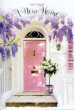 In this evocative doorway scene, the feeling is that of arriving at a new home in Northolt just as the light turns soft and forgiving. A pale pink front door, painted with a gentle, chalky finish, stands proudly in the centre, framed by sunlit white walls that glow with quiet warmth. Above, generous swathes of lavender wisteria trail down in dreamy cascades, each blossom-laden stem forming a natural arch that makes the entryway feel like a hidden garden. Their imagined scent blends with that of the roses below, bringing to mind the tranquil greenery of nearby parks and gardens. At the doorstep, resting directly on the stone, sits a stylish metal bucket in a muted grey, the kind a local florist might choose for its understated charm. From it spills a lavish arrangement of white and cream roses, their velvety petals layered in soft spirals, some tinged ever so slightly with ivory at the centre. Wisps of fresh green foliage are interspersed throughout, lending movement and a hint of countryside grace. A soft pink ribbon encircles the bucket, tied into a neat bow that mirrors the hues of the door and pulls the entire composition into a calm, pastel harmony. The light falling across the step creates gentle shadows that suggest the close of a long moving day, when friends or family might arrive with flowers to celebrate. This image conveys a quiet, hopeful joy-perfect for congratulating someone on their new address in Northolt and for capturing that tender pause between uncertainty and the feeling of truly being home.